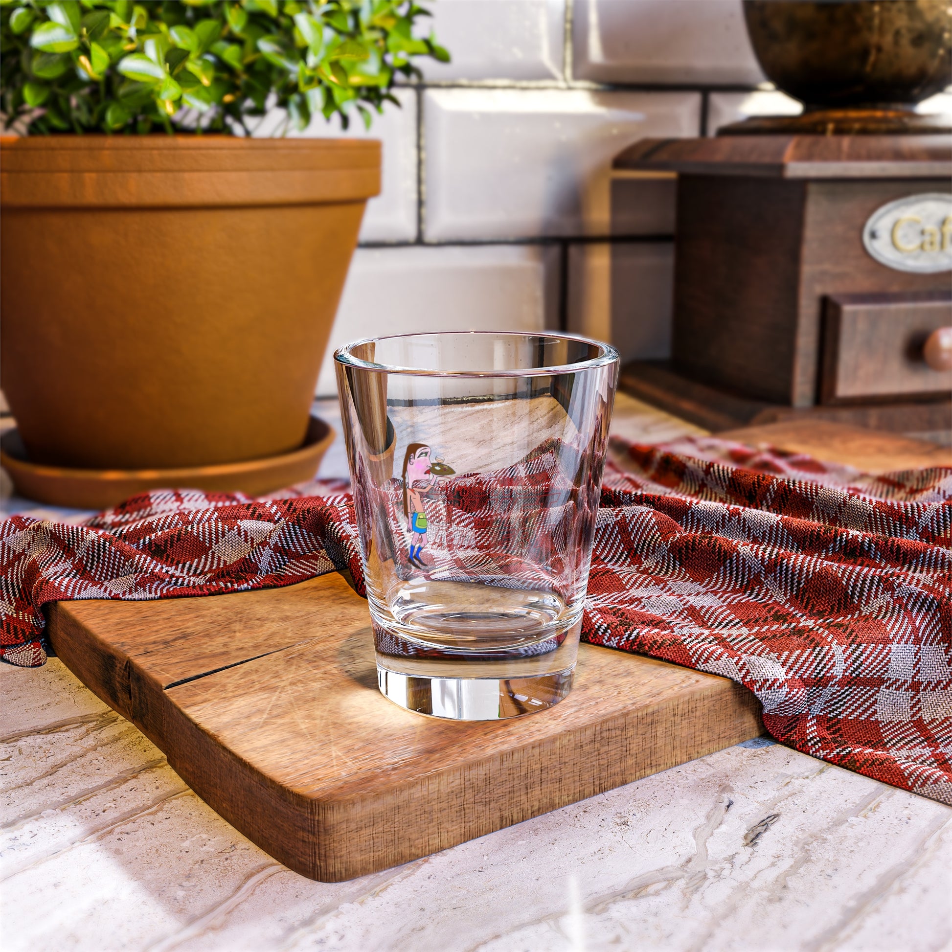 Clear glass on a wooden cutting board with a red and white checkered cloth in a kitchen setting.
