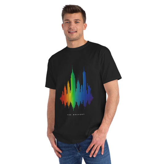 Man wearing a black organic T-shirt with a rainbow-colored NYC skyline shaped like a soundwave and the text "The Bravery" underneath — a tribute to the band.