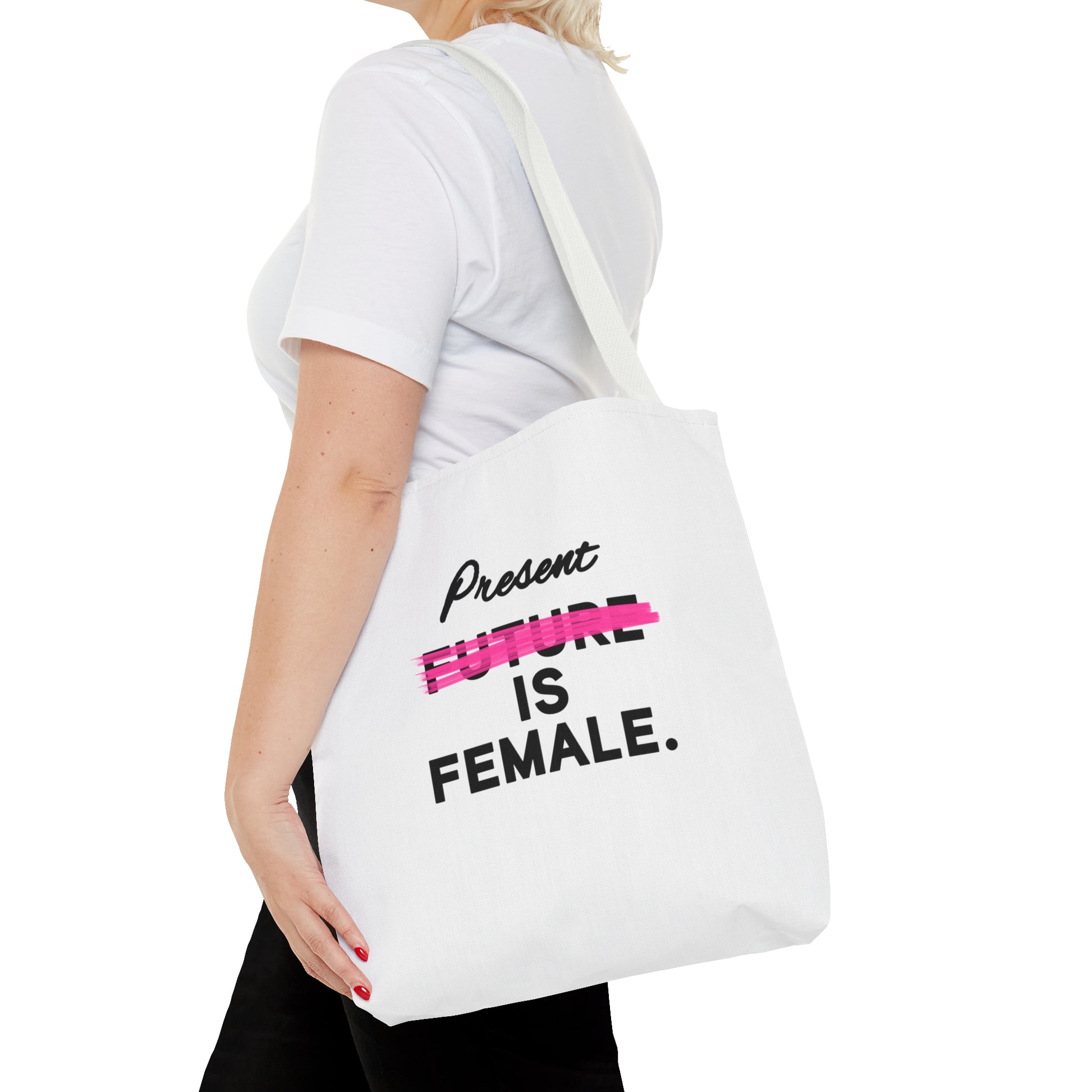 A white tote bag with the phrase "Present is Female" and "Future" crossed out in pink