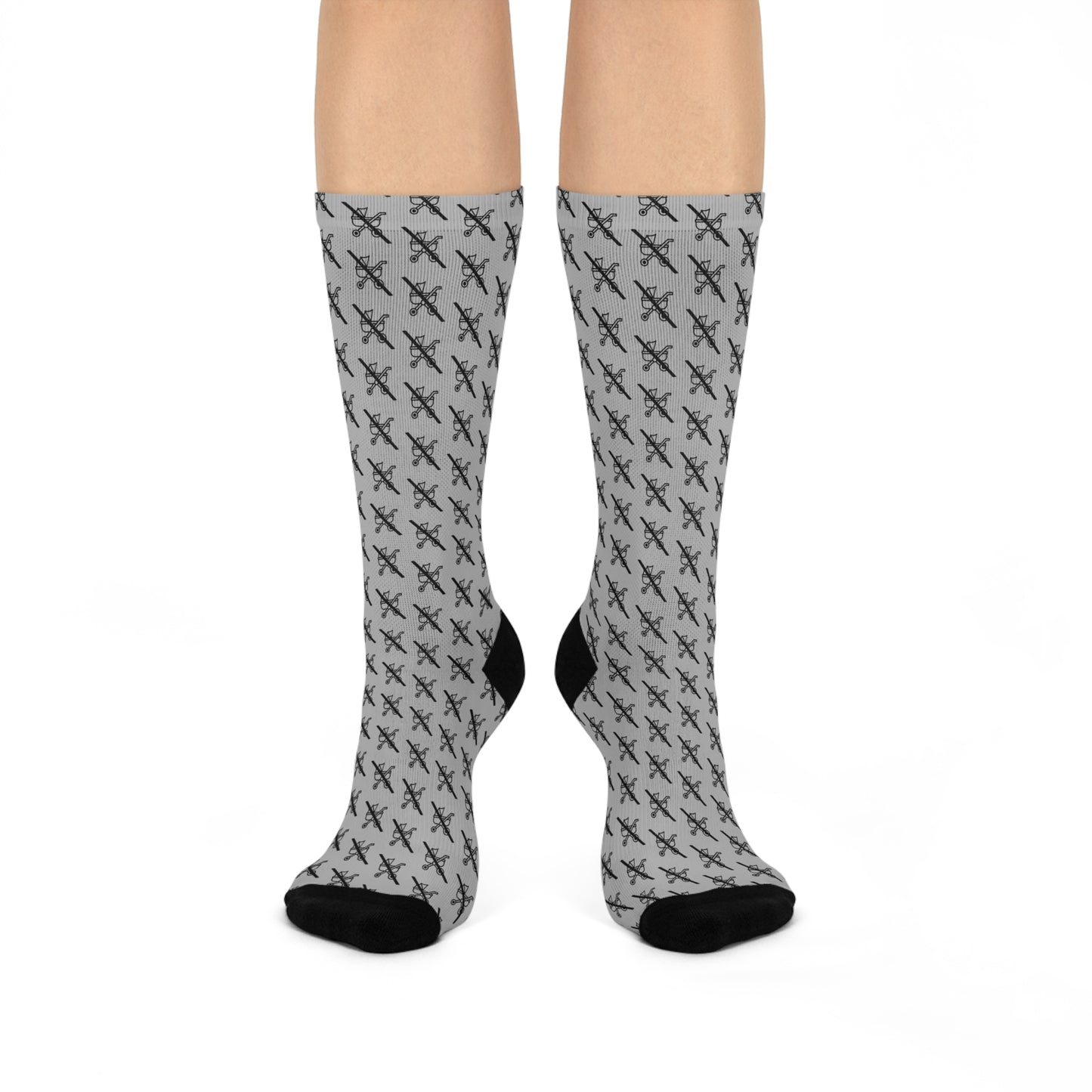 Pair of grey Proudly Childless crew socks with black accents shown on legs standing straight