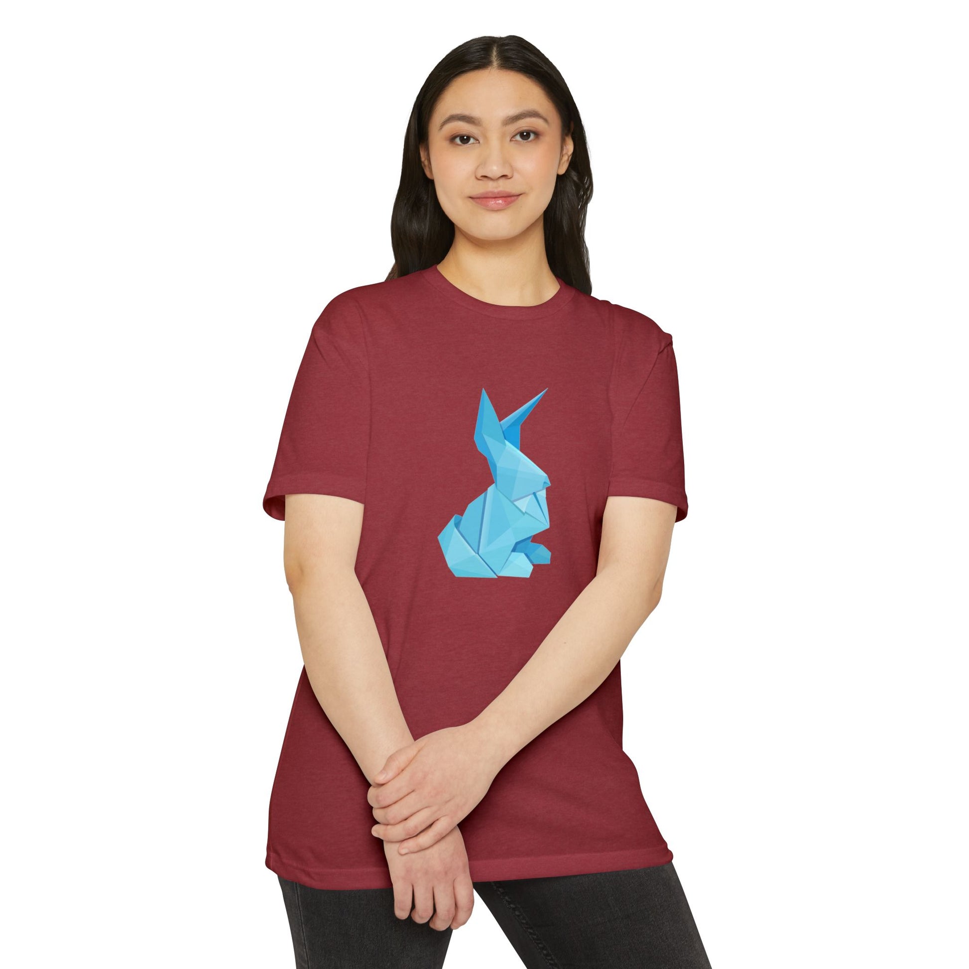 Woman in red Origami Bunny T-Shirt with blue origami bunny print, hands clasped in front.