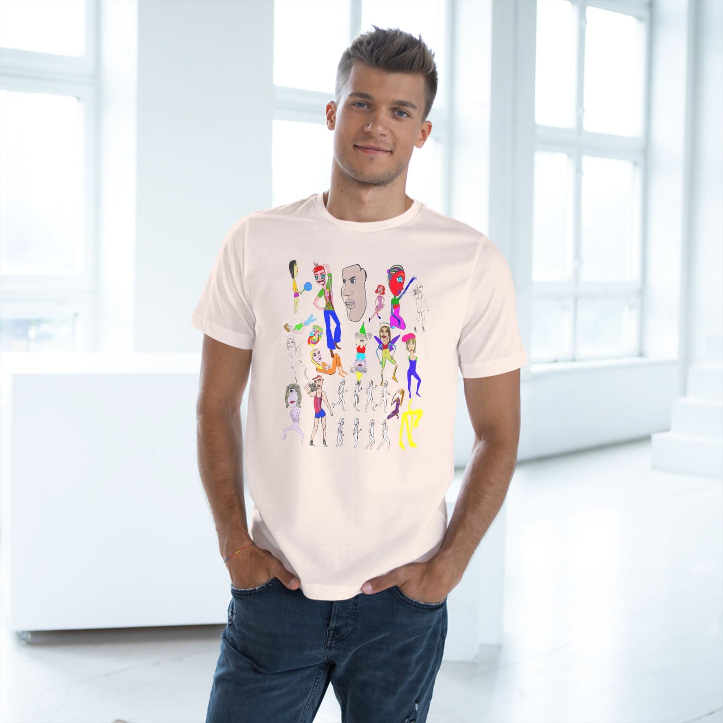 Man wearing a light pink t-shirt with colorful graphic design in a bright room.