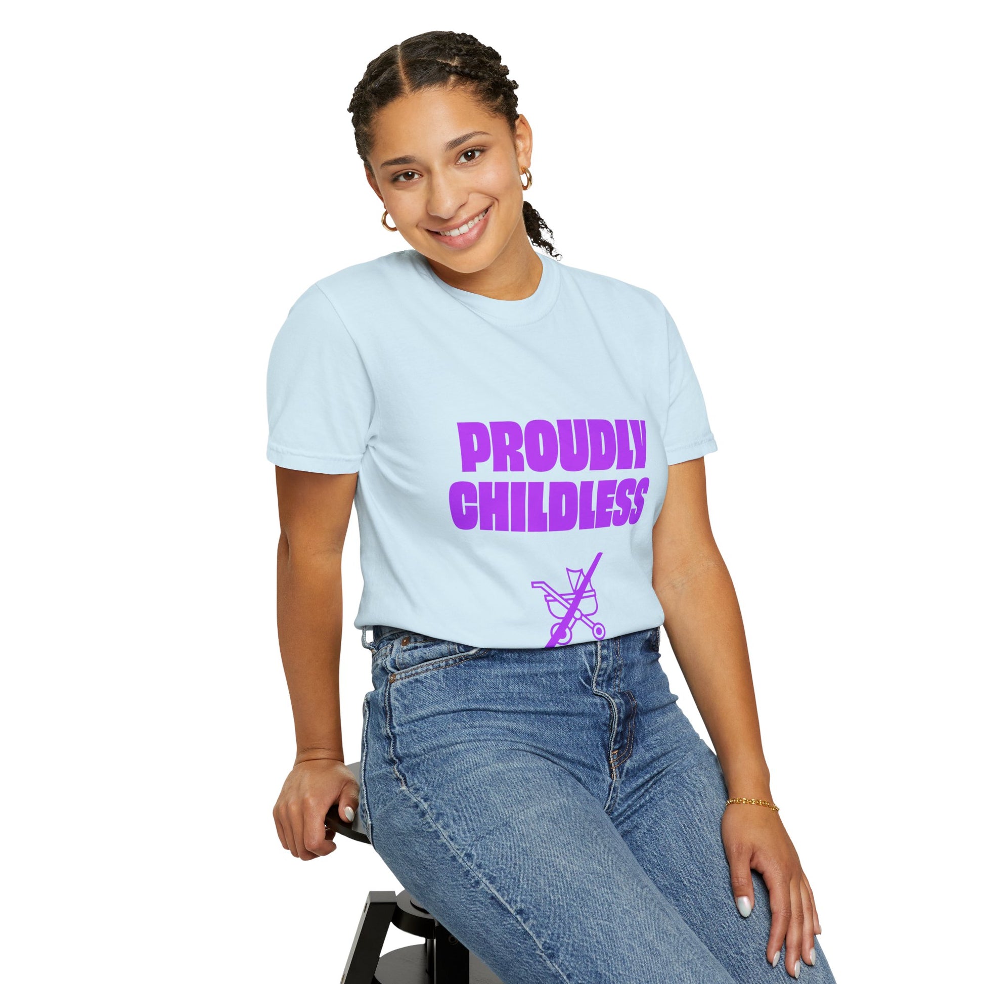 Woman sitting wearing light blue Proudly Childless T-Shirt with purple text