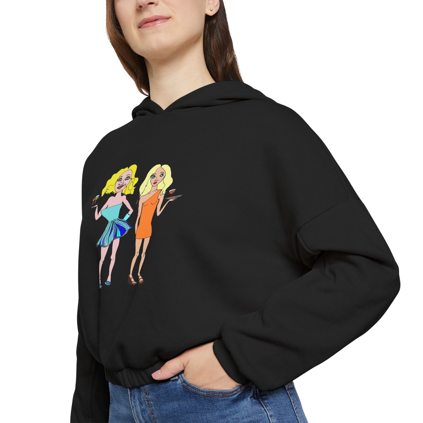 Side angle of woman wearing black waitress hand-drawn hoodie, hands in pockets.