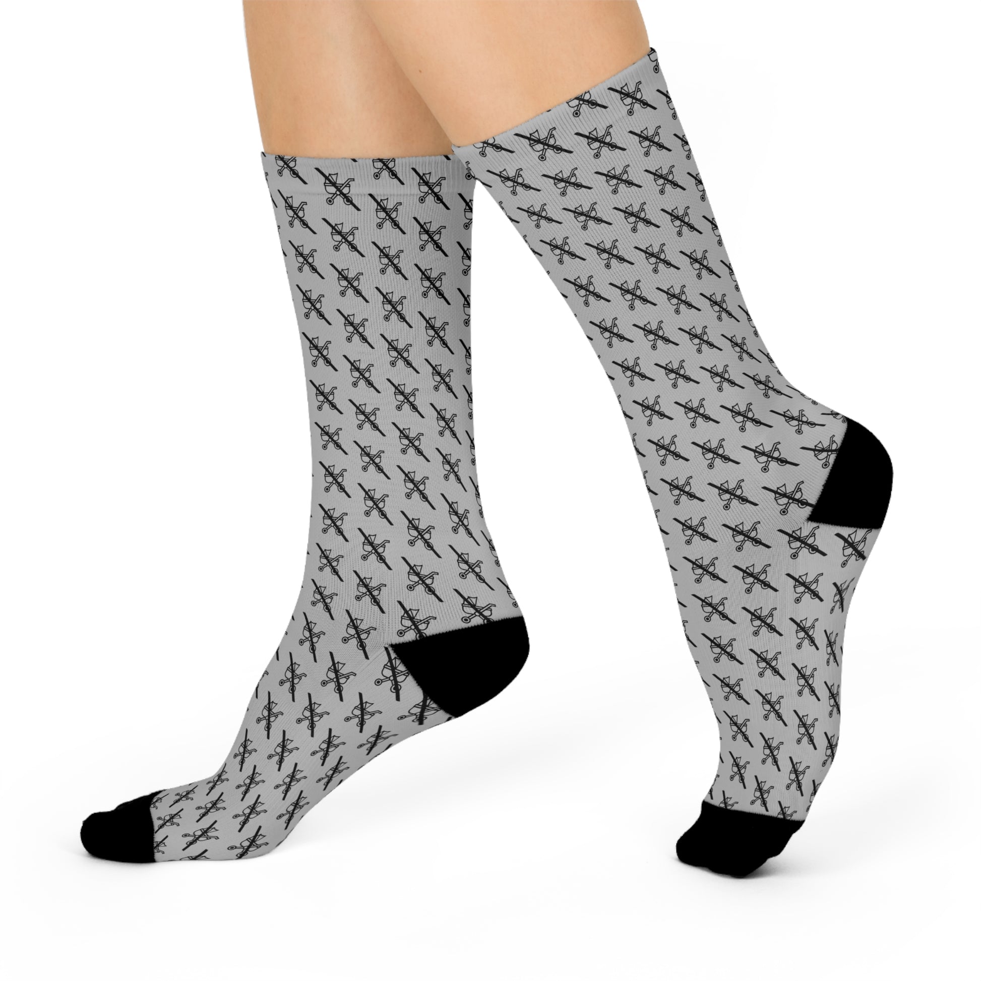 Grey Proudly Childless crew socks with black heel and toe shown in side profile view on legs