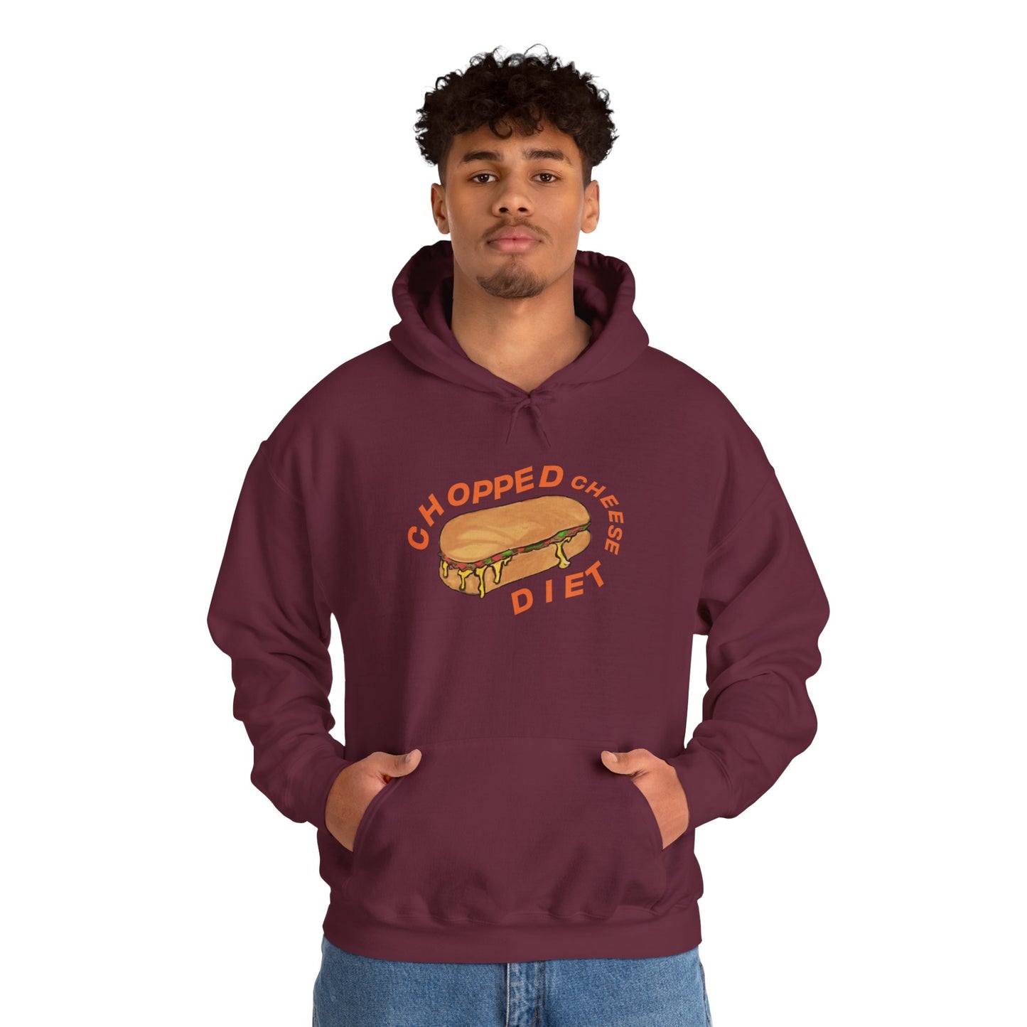 Person wearing maroon hoodie with “Chopped Cheese Diet” sandwich graphic, hands in front pocket.