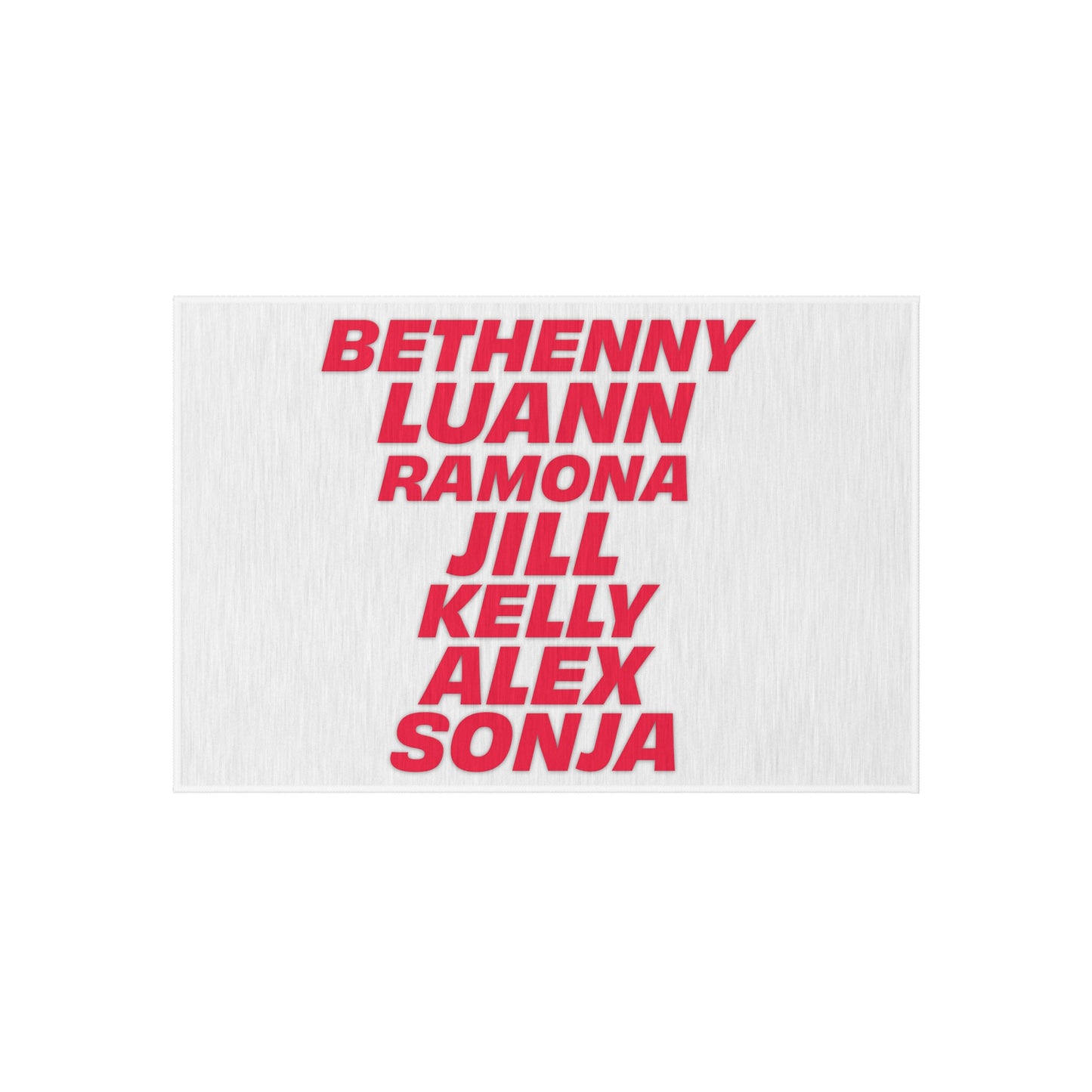 Flat product view of OG NY Housewives outdoor rug showing stacked red typography cast names design on white background