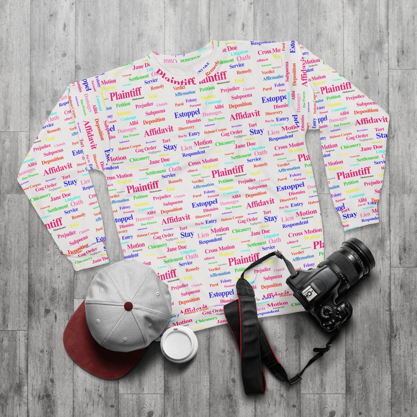 Flat lay of Legalese Sweatshirt crew neck with colorful legal jargon print styled with accessories, part of the Legal Collection.