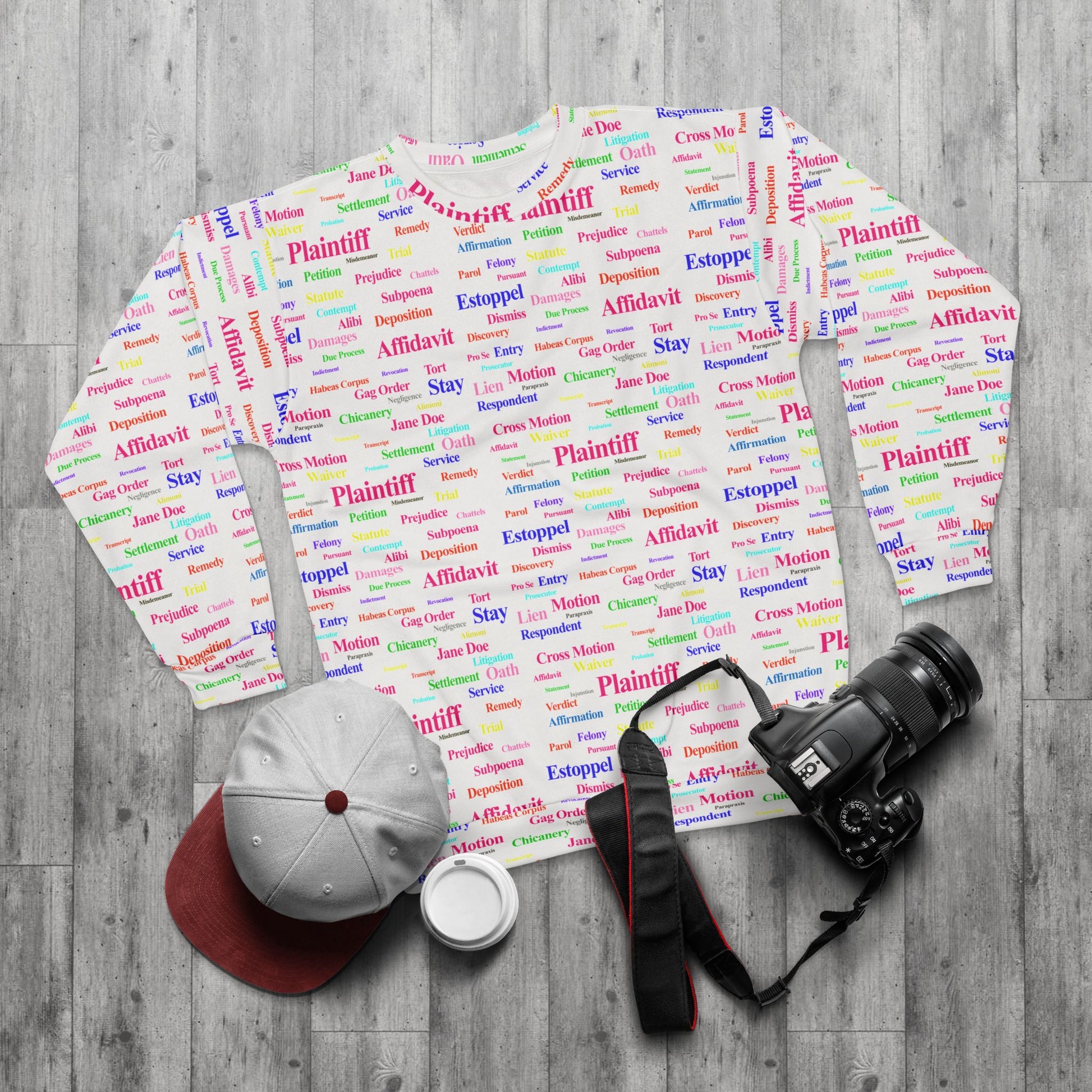 Flat lay of Legalese Sweatshirt crew neck with colorful legal jargon print styled with accessories, part of the Legal Collection.