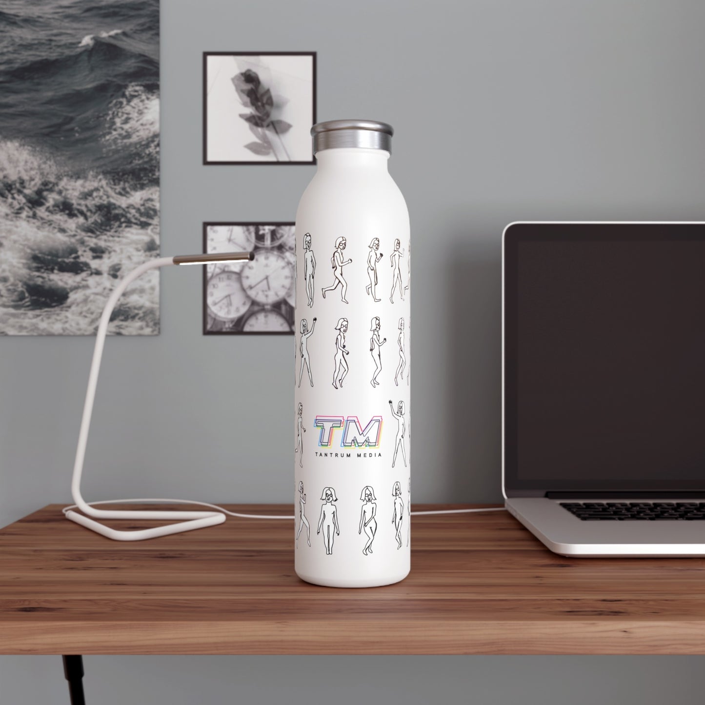 unning Out Water Bottle with artsy logo design on a desk beside a laptop and notebook
