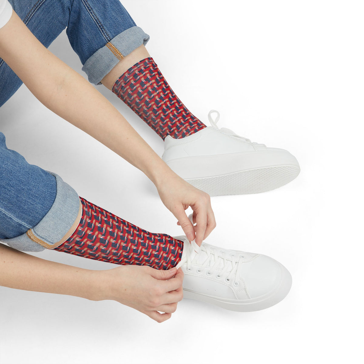 Close-up of Donald Trump red crew socks worn with white sneakers and cuffed jeans