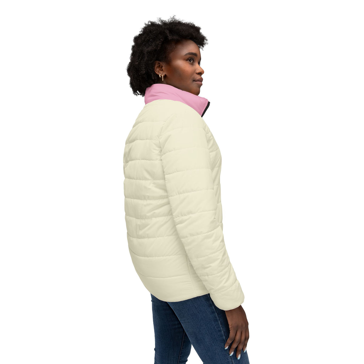 Side view of woman wearing Pac-Man Pink Ghost women’s cream and pink puffer jacket