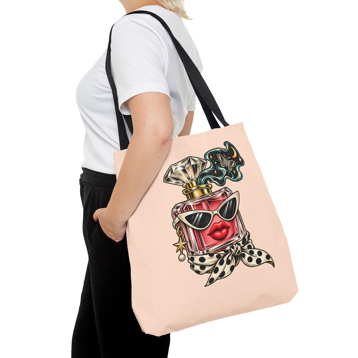 Side view of a man carrying the large peach Scent of Chaos tote bag over his shoulder, showing its square shape, black straps and surreal artwork.