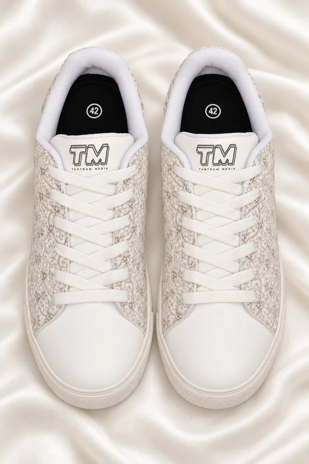 Women’s bridal lace wedding sneakers flat lay on soft ivory satin