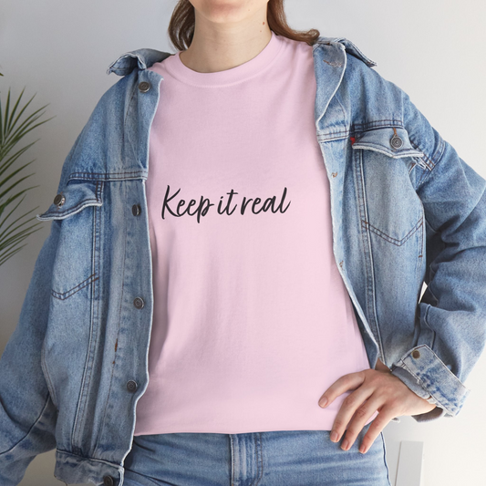 Detail of the front of a pink t-shirt that says "Keep it real"