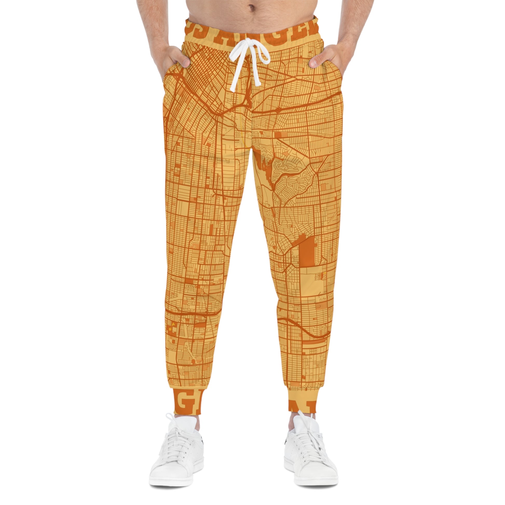 Model wearing orange Los Angeles map print joggers front view with white sneakers.