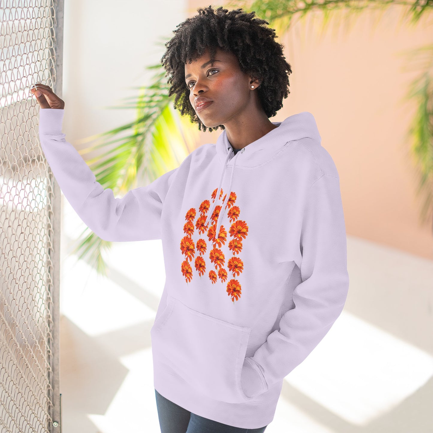 Woman wearing lavender Zinnia Hoodie posing near window