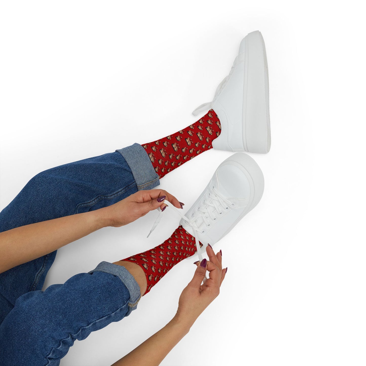 Red Betty Boop socks paired with white sneakers and rolled-up jeans on a clean studio background