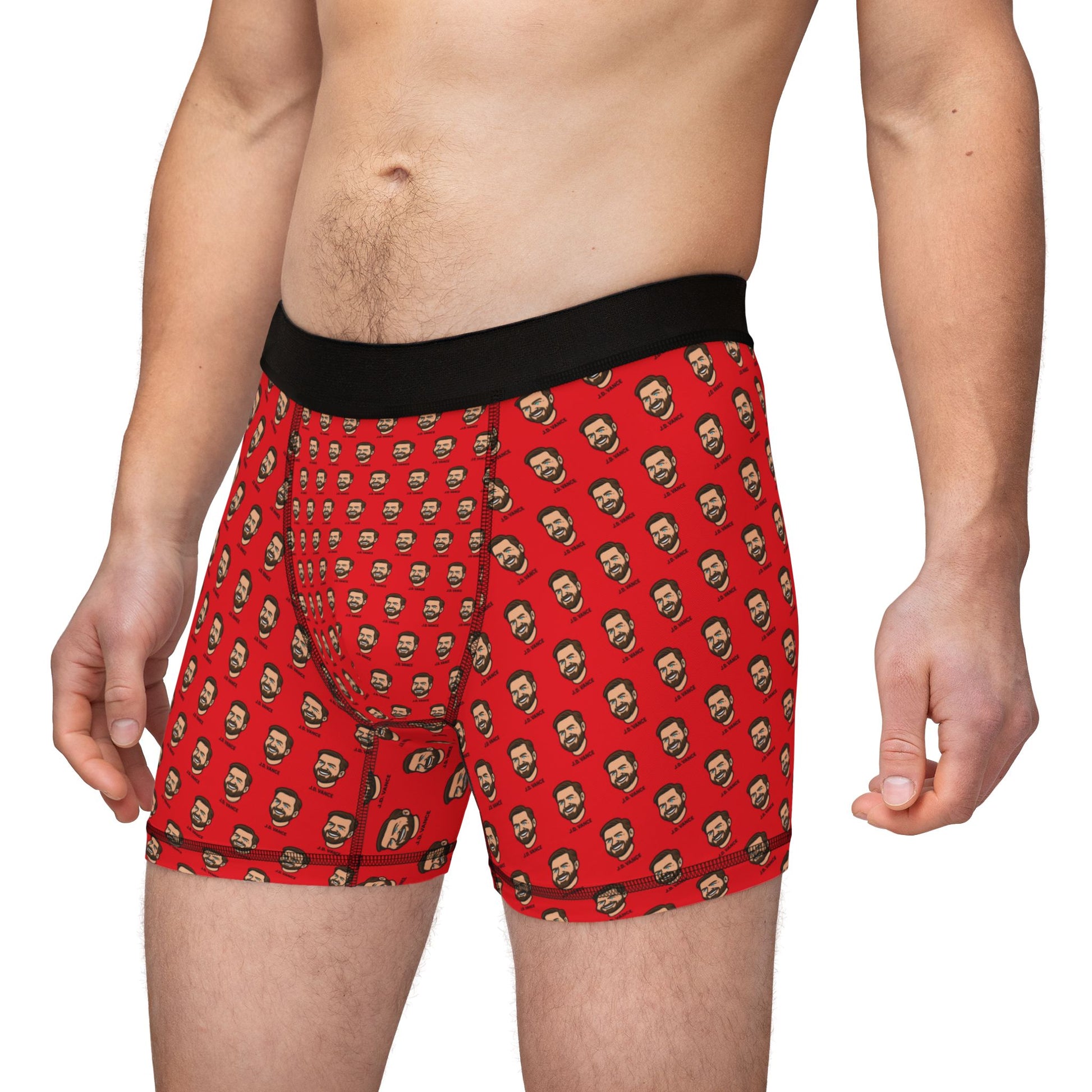 Front angled view of a man wearing J.D. Vance Boxer Briefs with a red background and repeating cartoon face print.