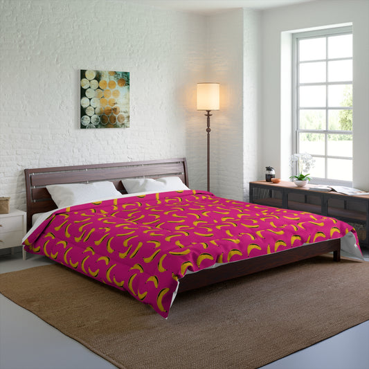Comforter with bold banana print in pop art style on a modern bed in a bright room