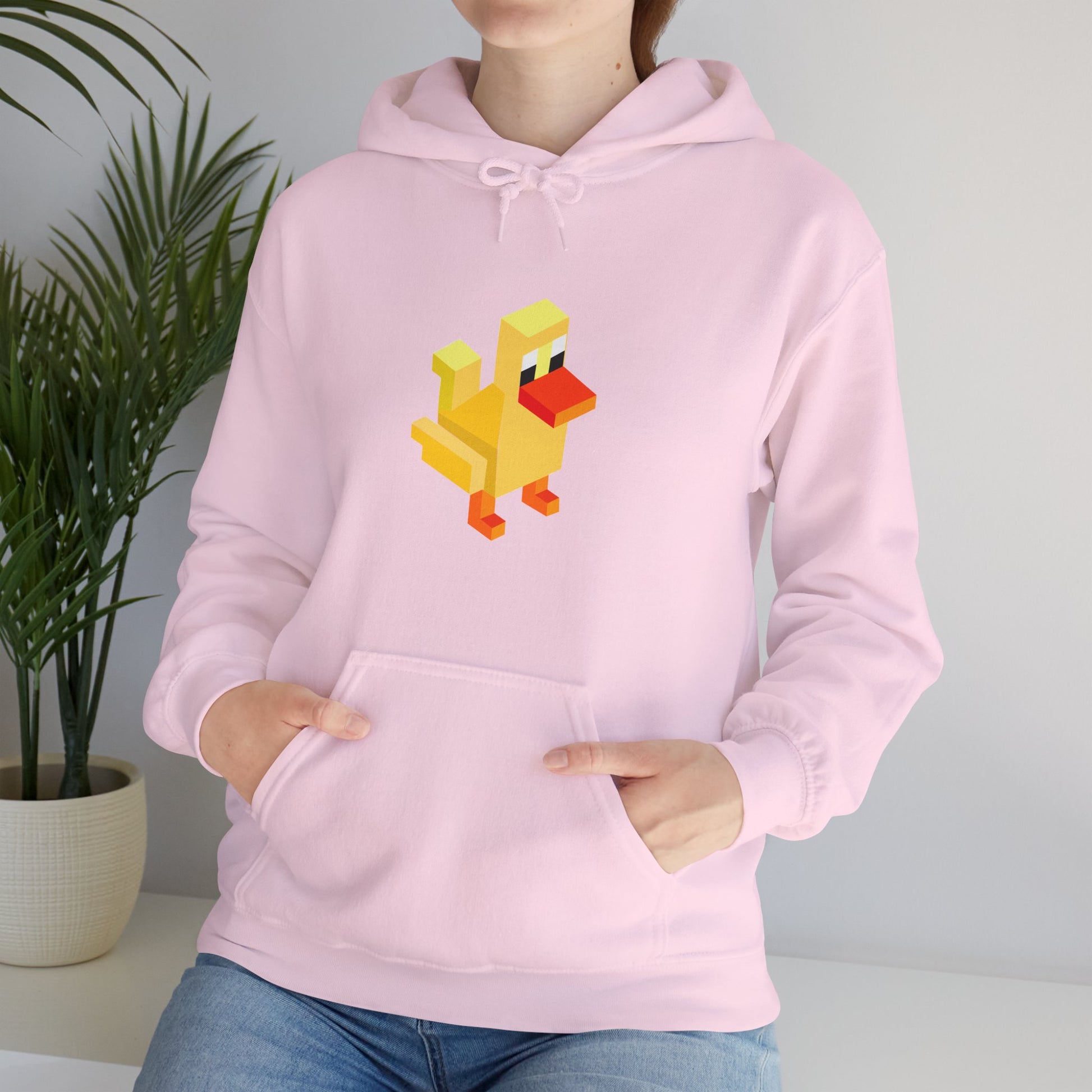 Woman wearing light pink pixel duck hoodie, cute retro gaming streetwear unisex sweatshirt