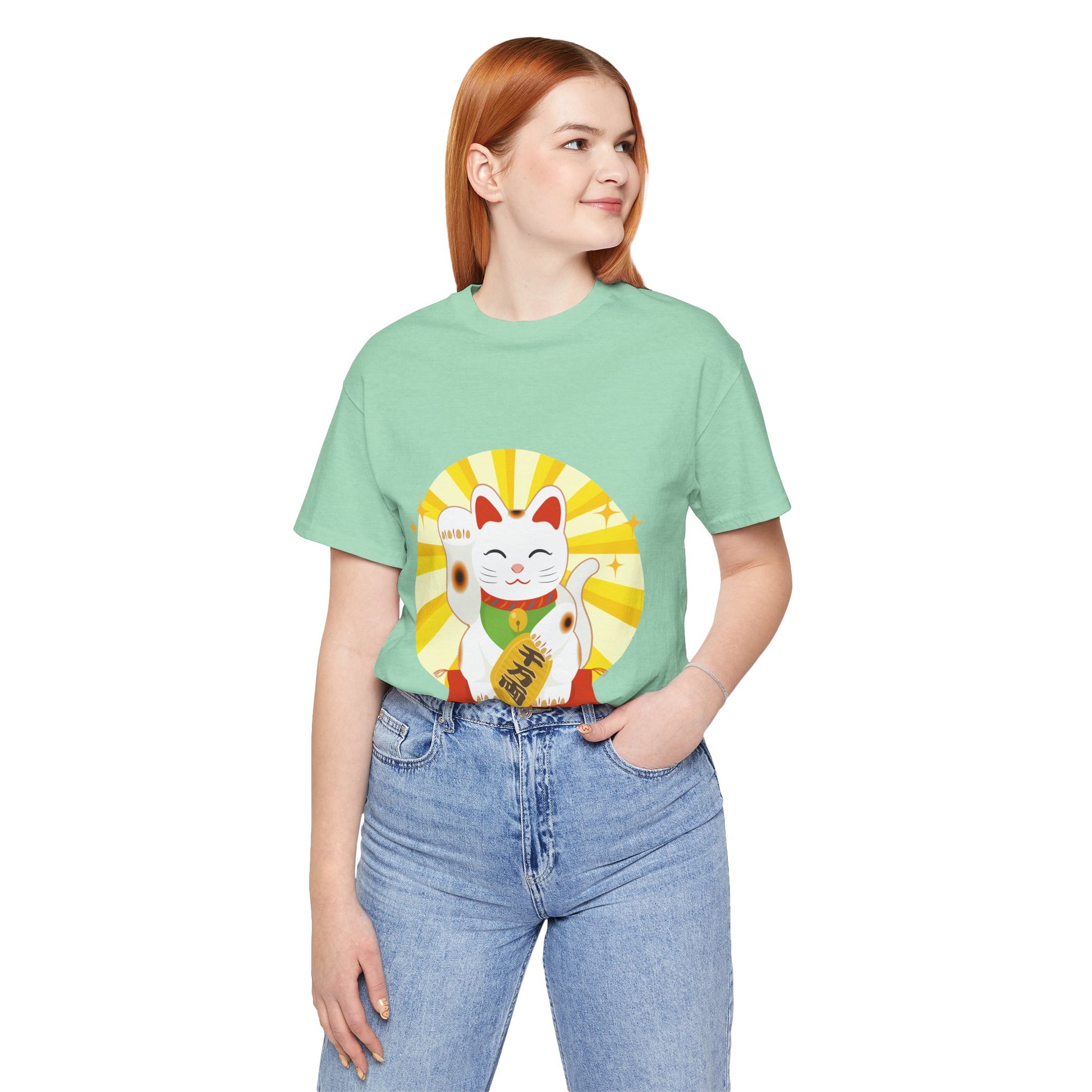 Person wearing a light green t-shirt with a cat graphic design on a white background