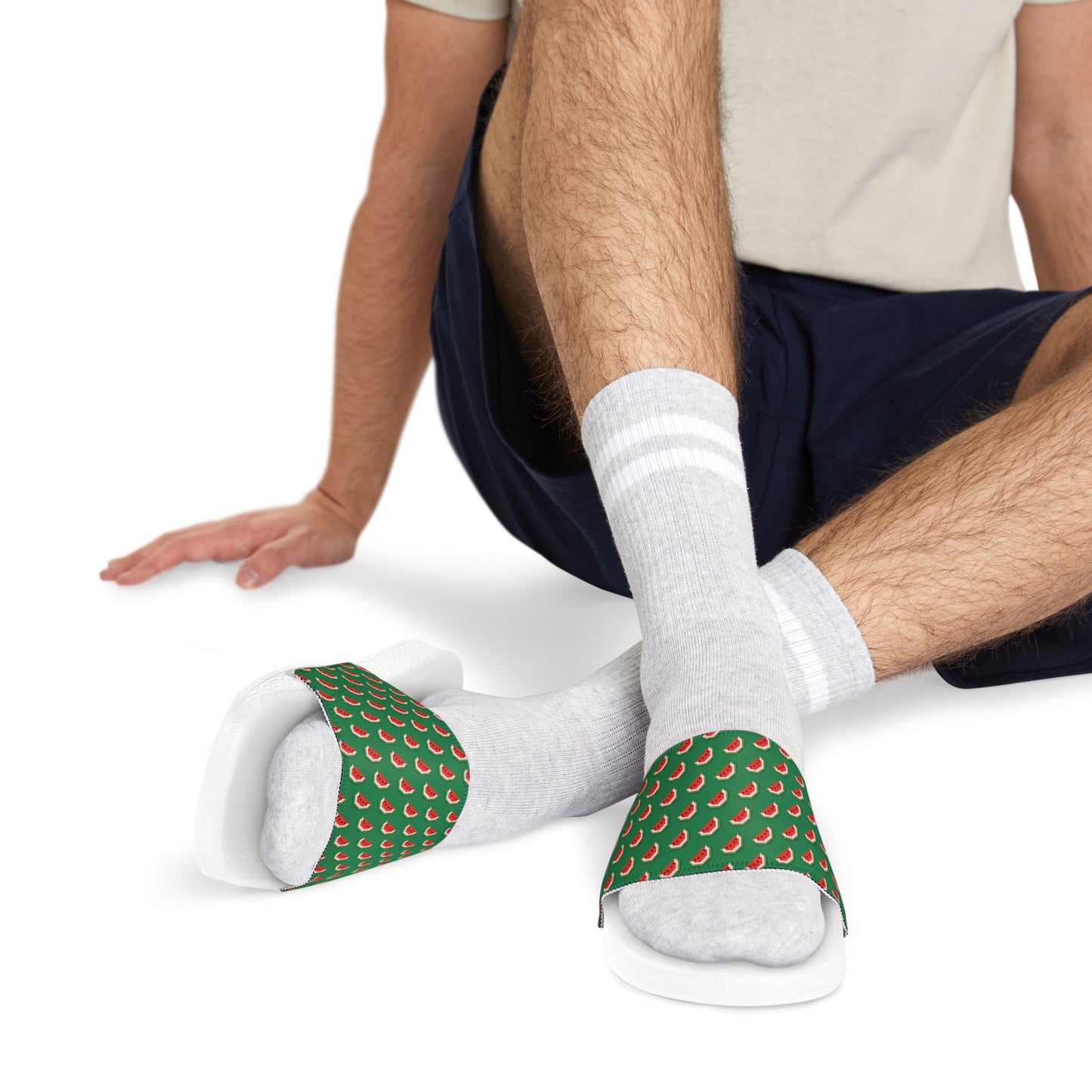 Close-up of man wearing Watermelon Green Slide Sandals with black soles and patterned straps over white socks.