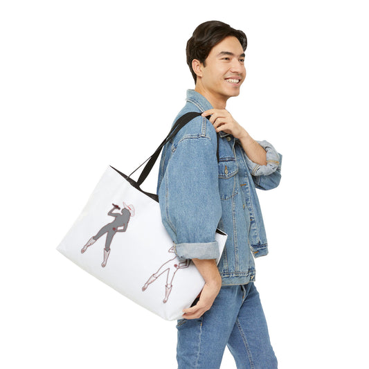 Person wearing tee and jeans holding Bey Country Weekender Tote Bag, front graphic visible.
