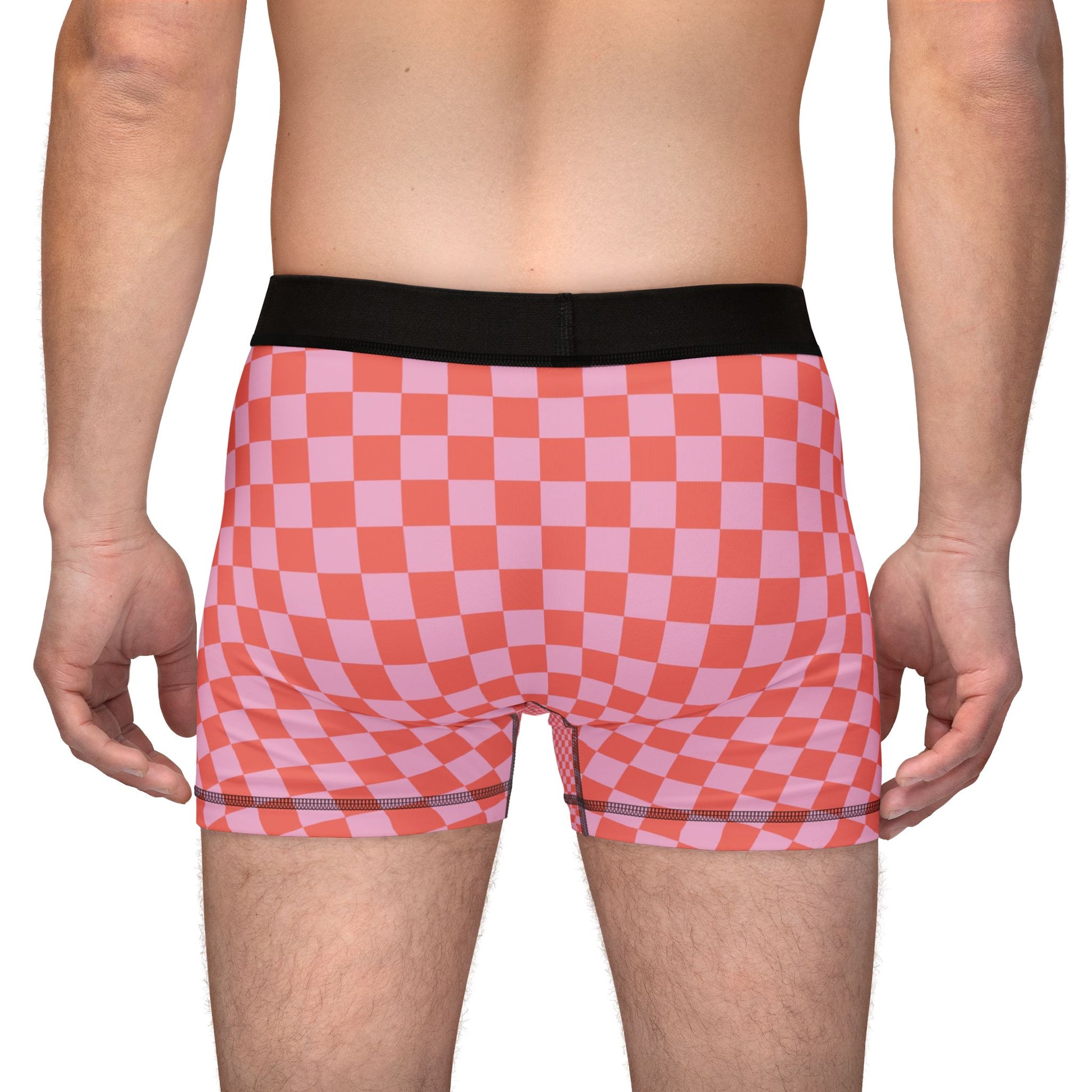 Back view of man wearing AOC checkered boxer briefs showing full rear pattern.