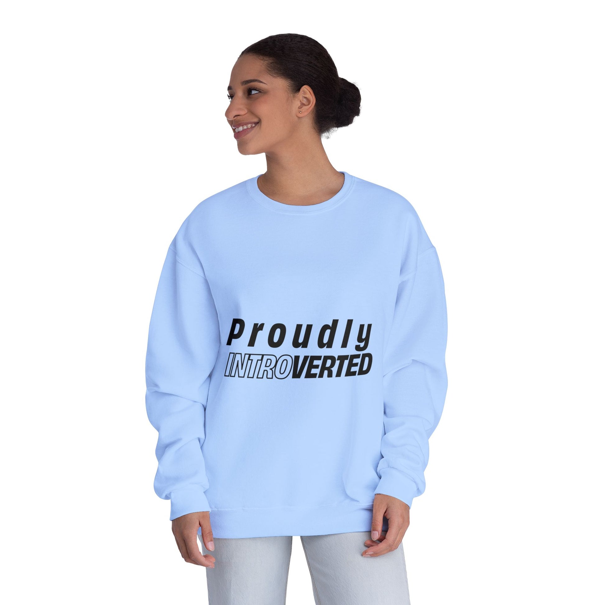 Female model in blue Proudly Introverted Sweatshirt smiling, hands behind back