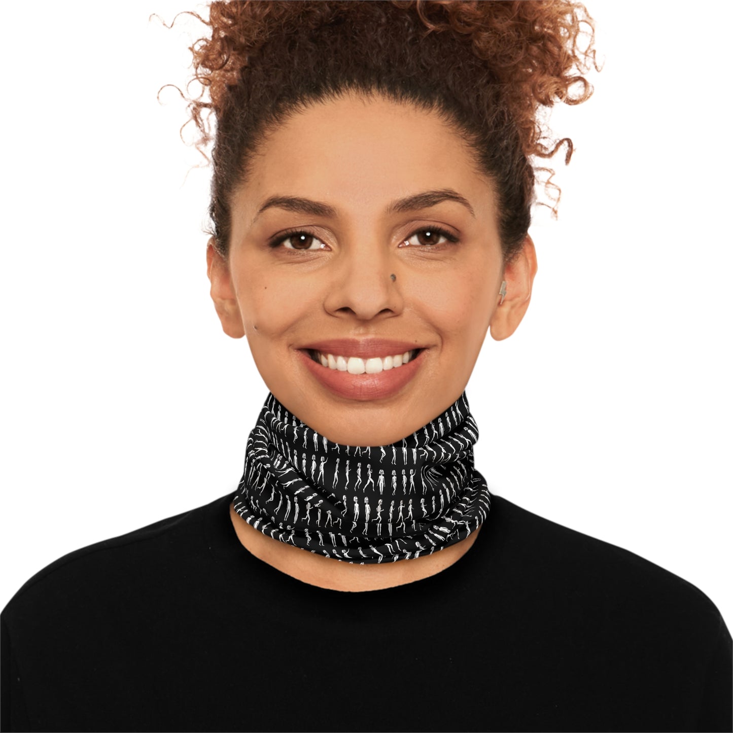 Woman smiling while wearing black patterned tube scarf around neck