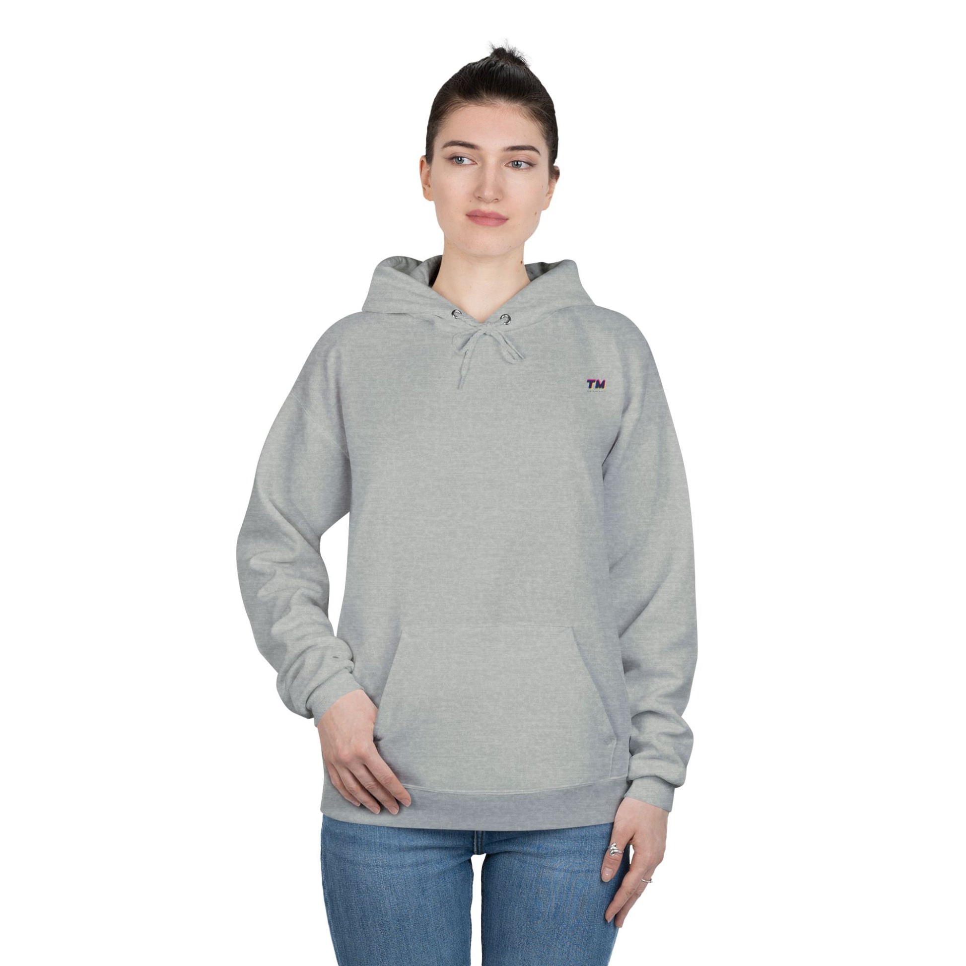 Woman wearing gray EcoSmart hoodie with hands in pockets.