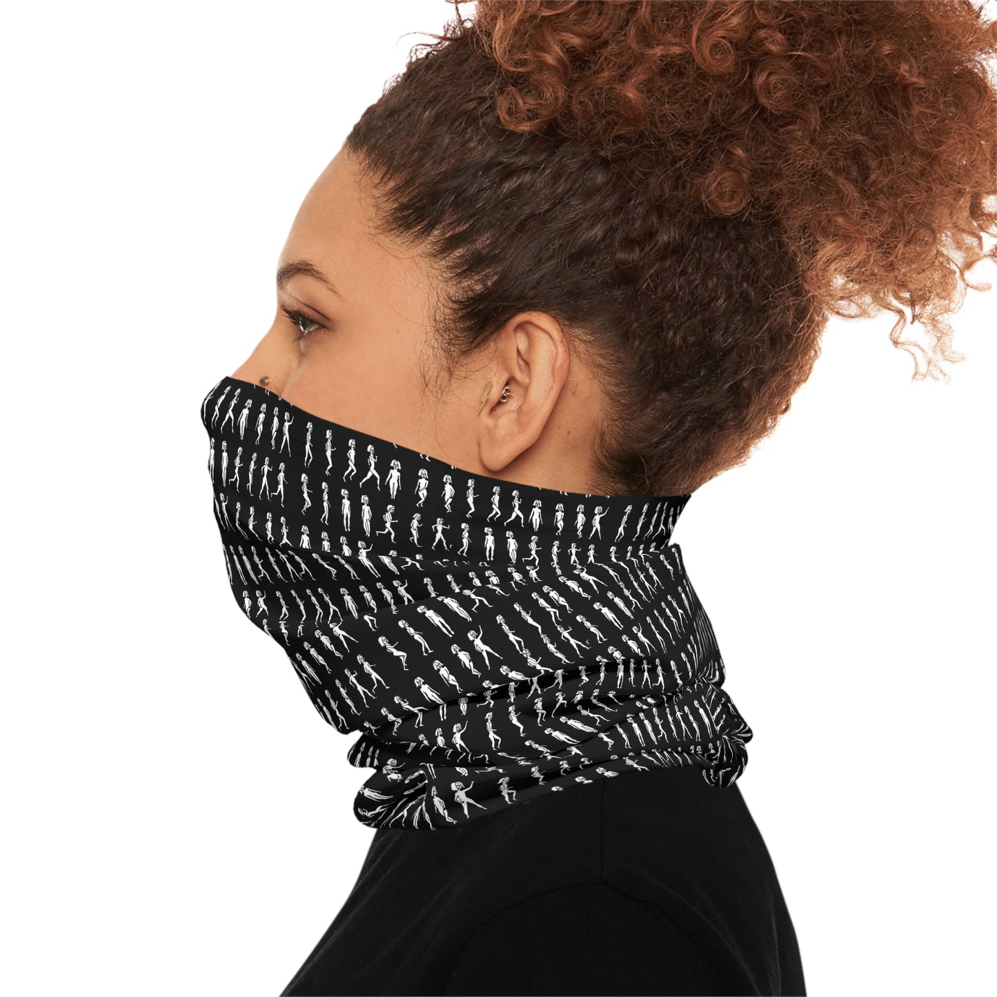 Side view of woman wearing black patterned tube scarf covering lower face and neck