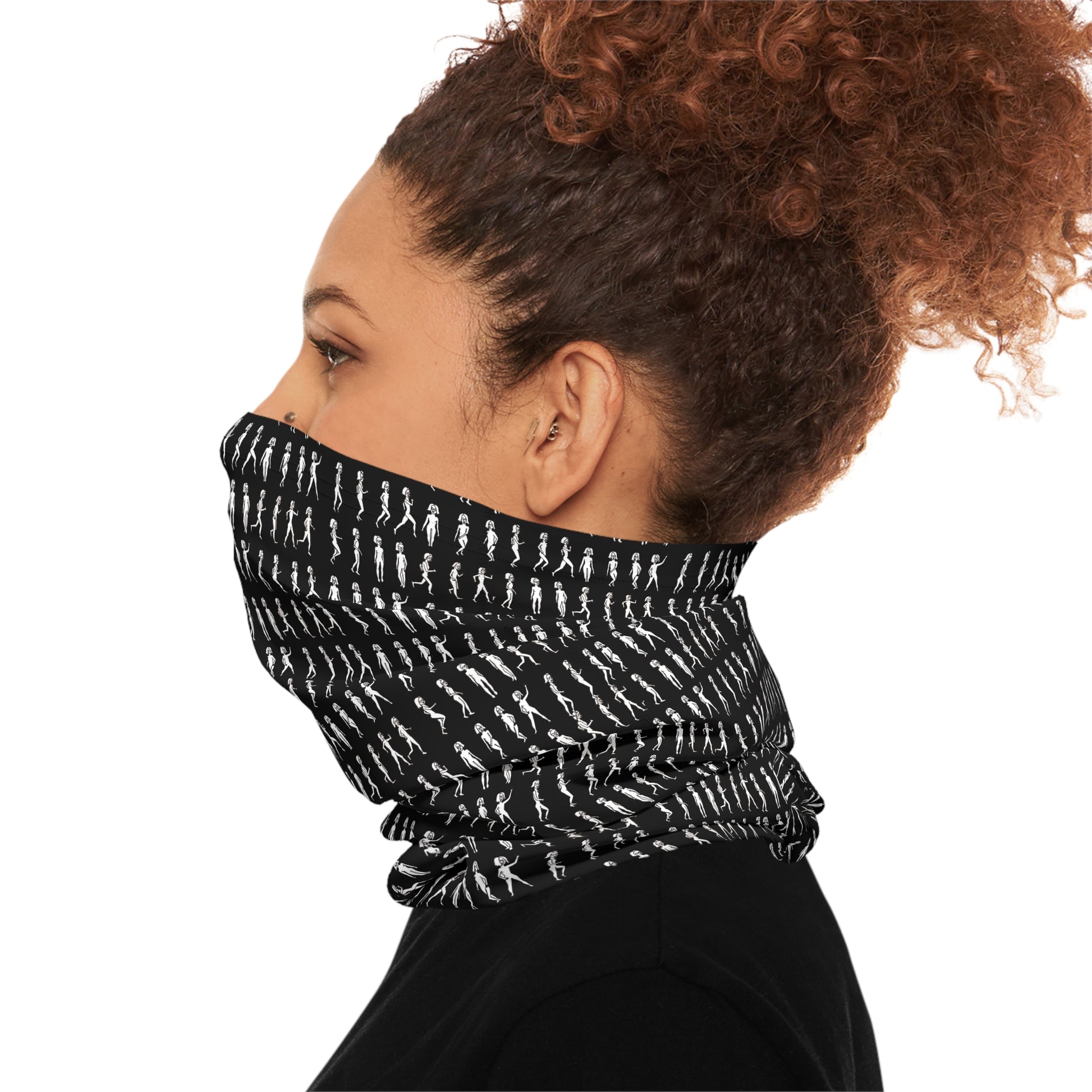 Side view of woman wearing black patterned tube scarf covering lower face and neck