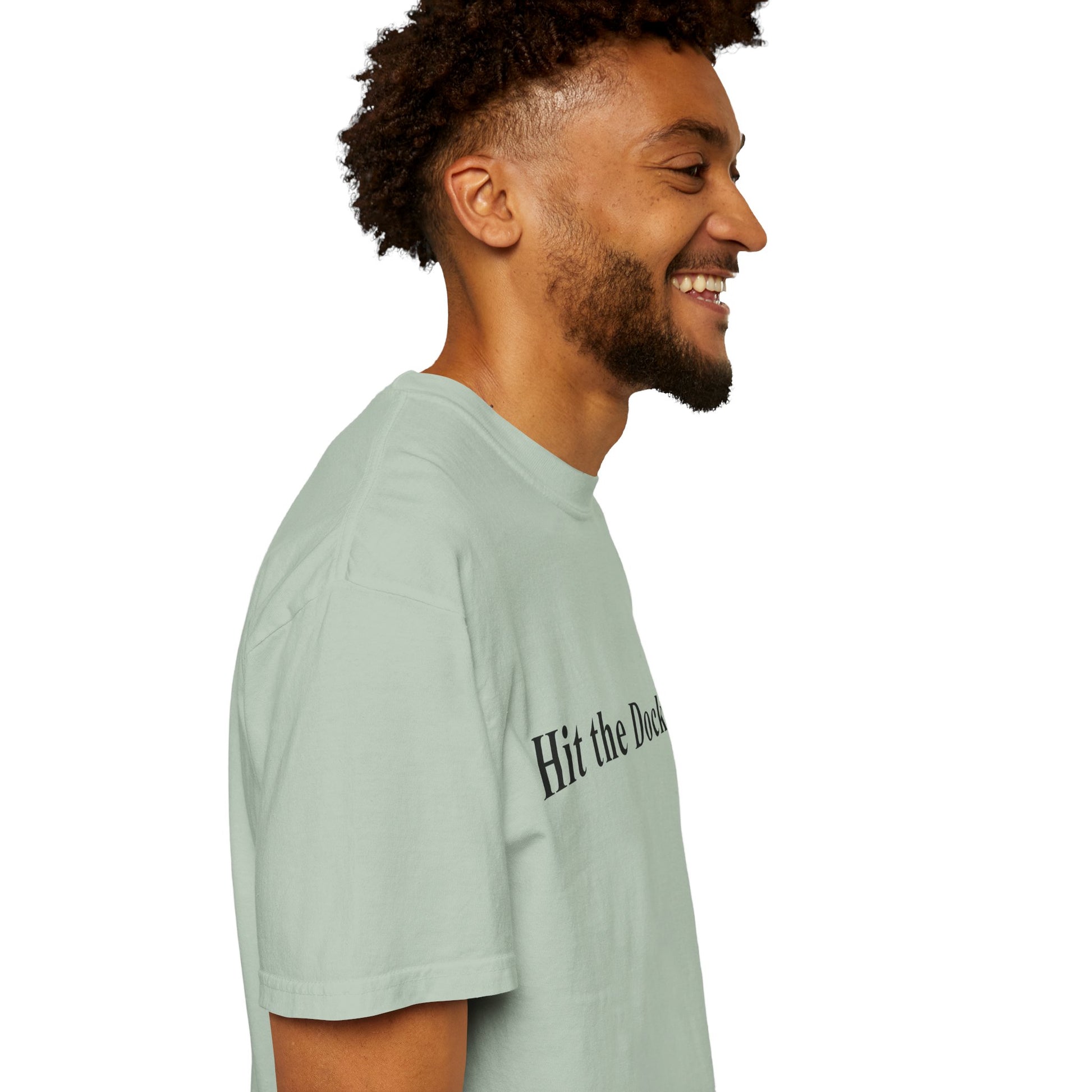Man wearing a light green t-shirt with text on a white background