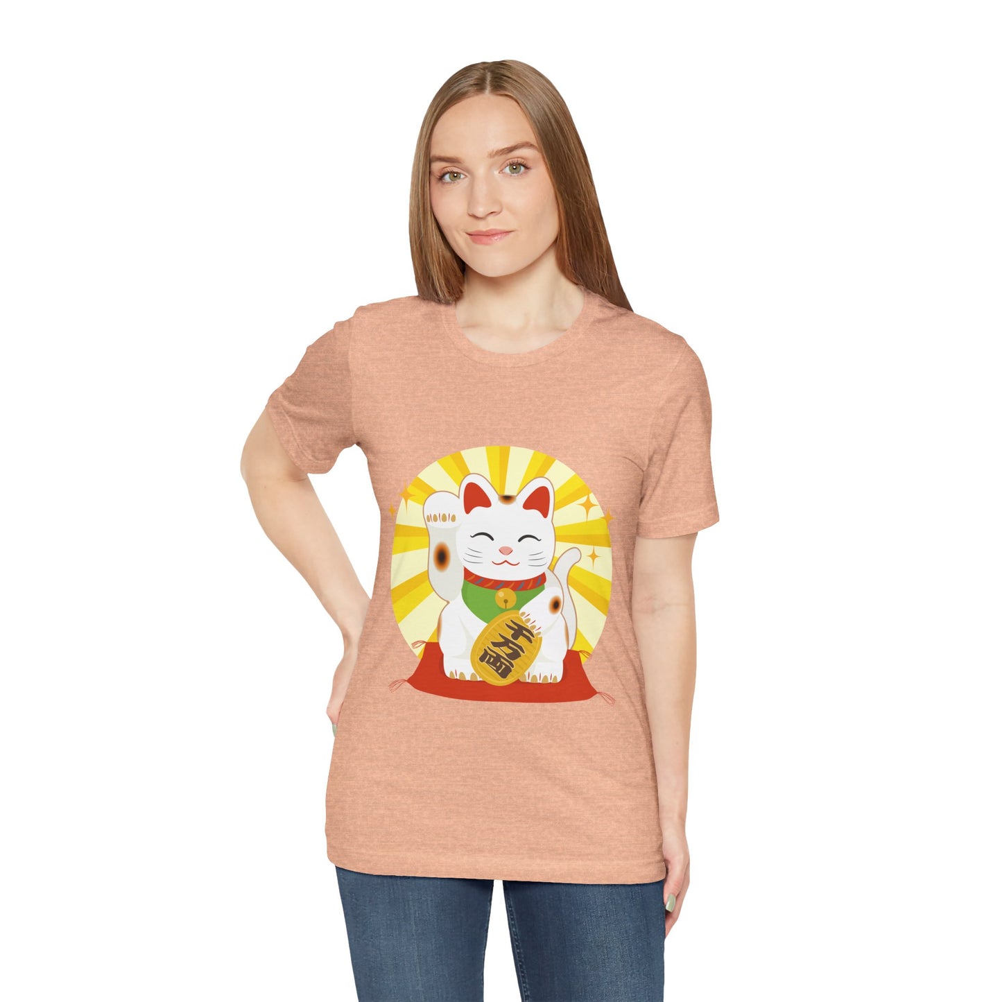 Woman wearing a peach t-shirt with a lucky cat graphic on a white background