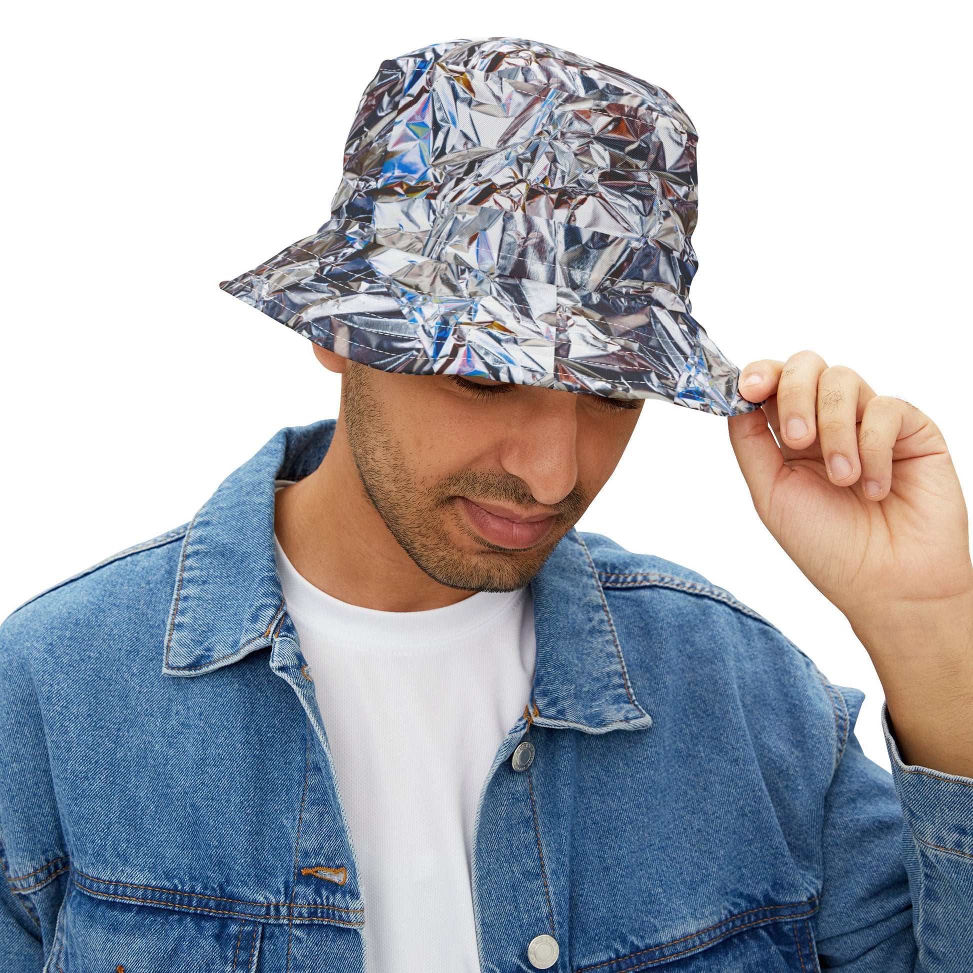 Man wearing Tinfoil Bucket Hat with metallic foil design, holding brim while looking down