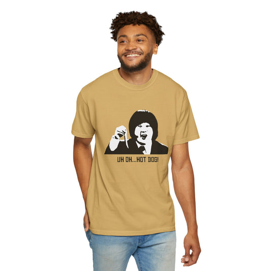 Man wearing Uh Oh Hot Dog Bobby Lee T-shirt in tan color, smiling and standing.