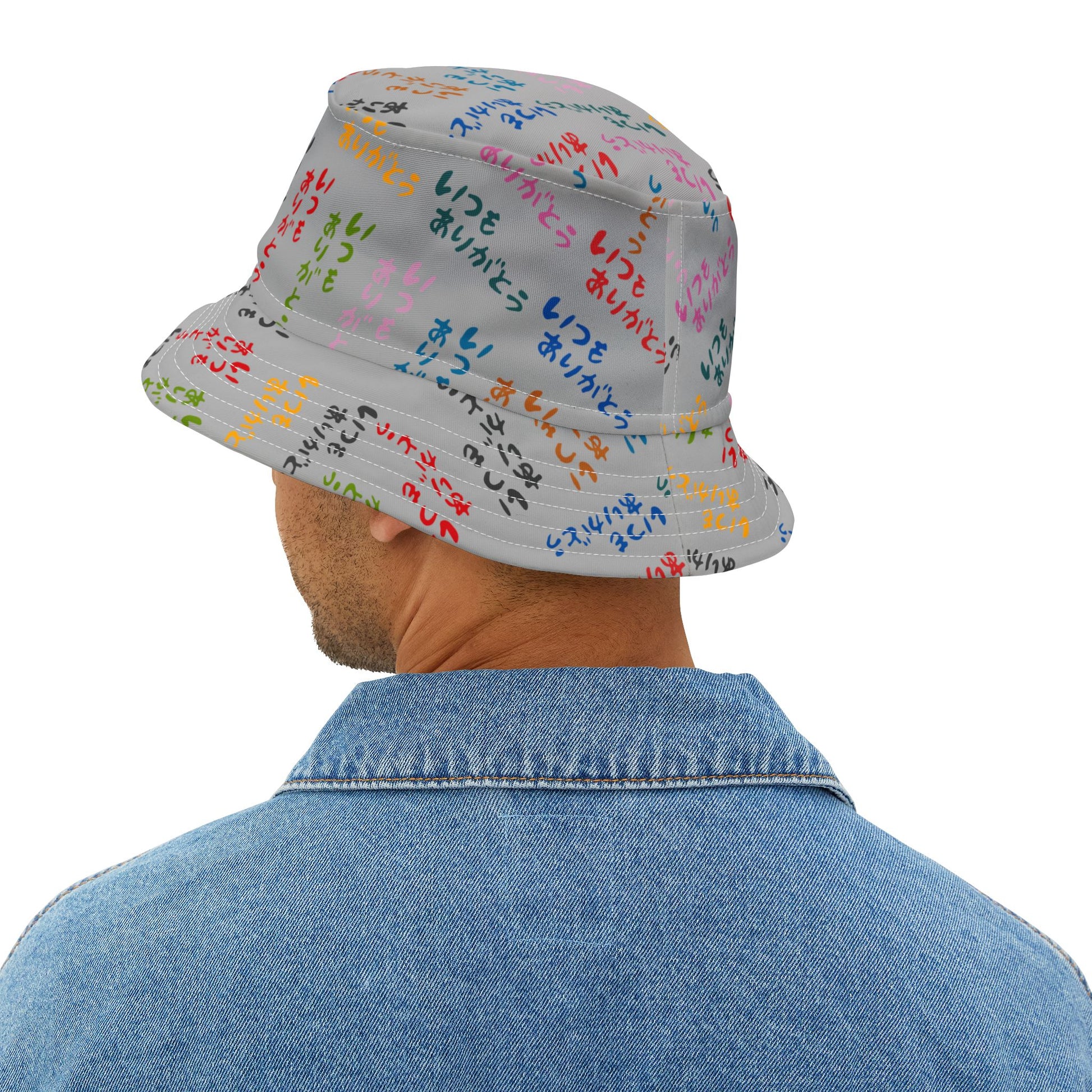 Person wearing a colorful bucket hat with text on a white background