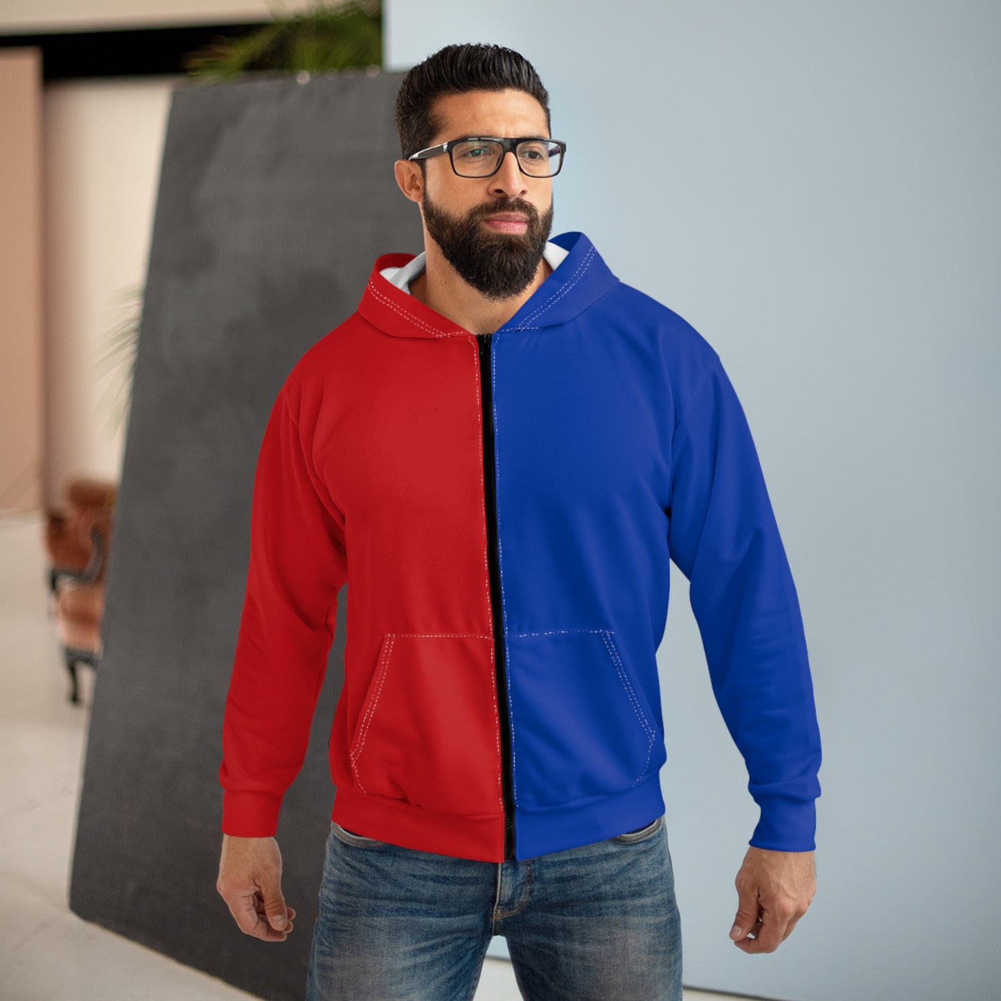 Man wearing a red and blue half and half hoodie in city setting