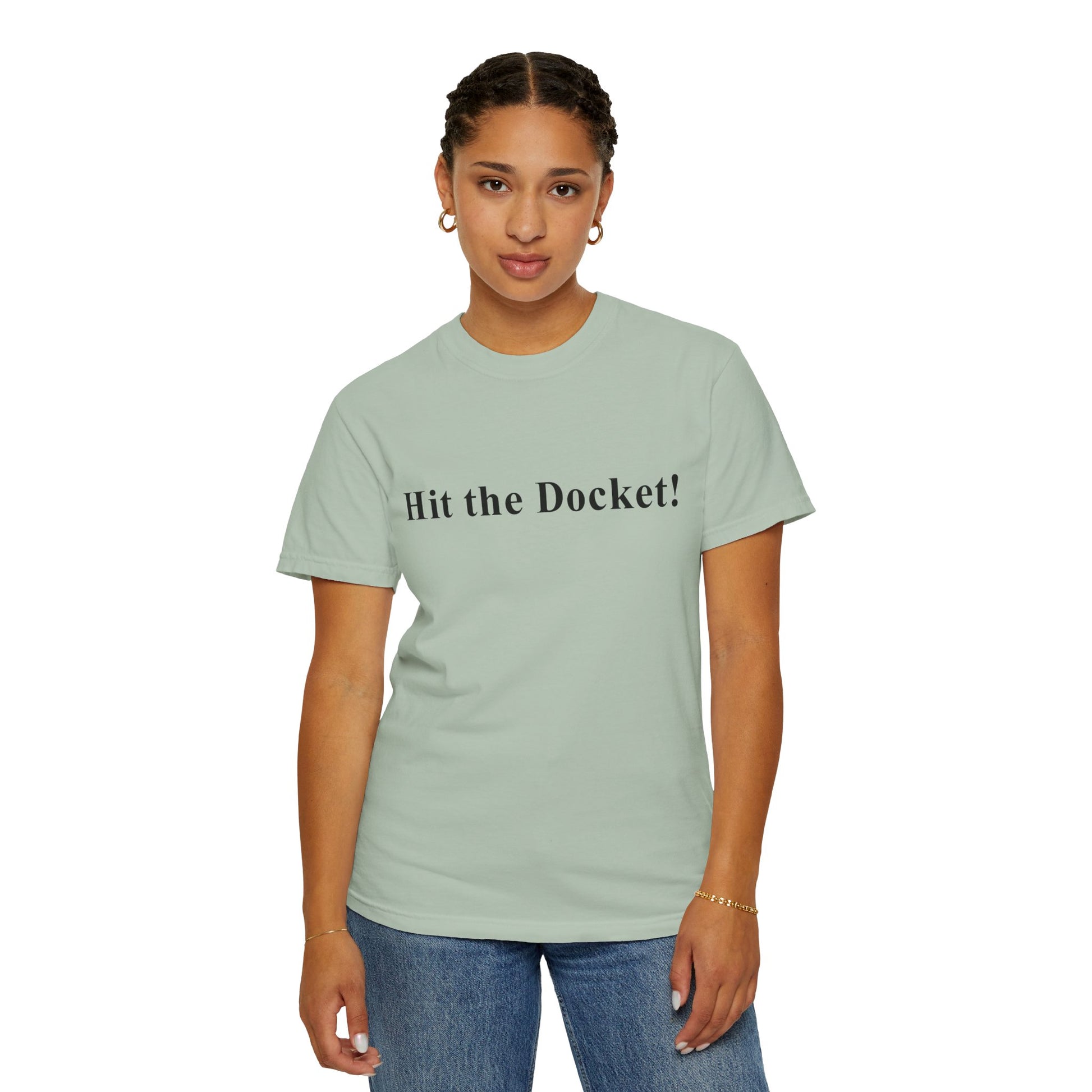 Young woman wearing a light green t-shirt with 'Hit the Docket!' text on a white background
