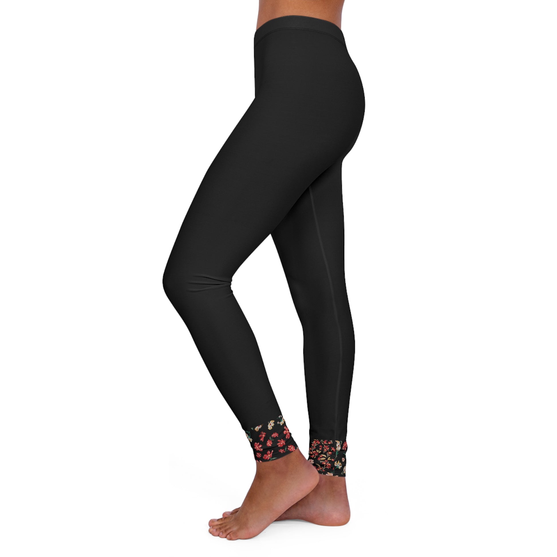 Side view of black leggings with floral ankle detail.