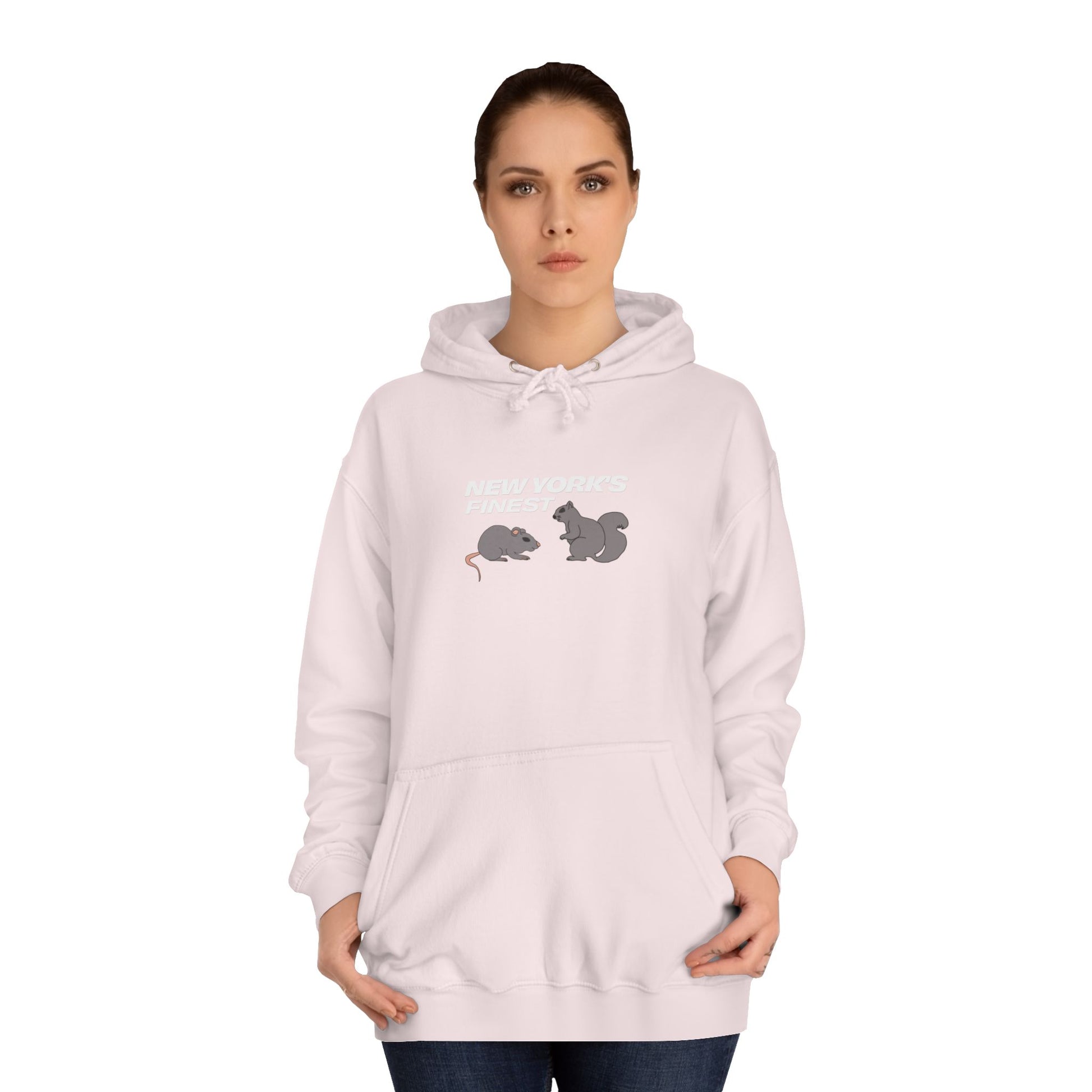Woman wearing a light pink hoodie with graphic designs on a white background