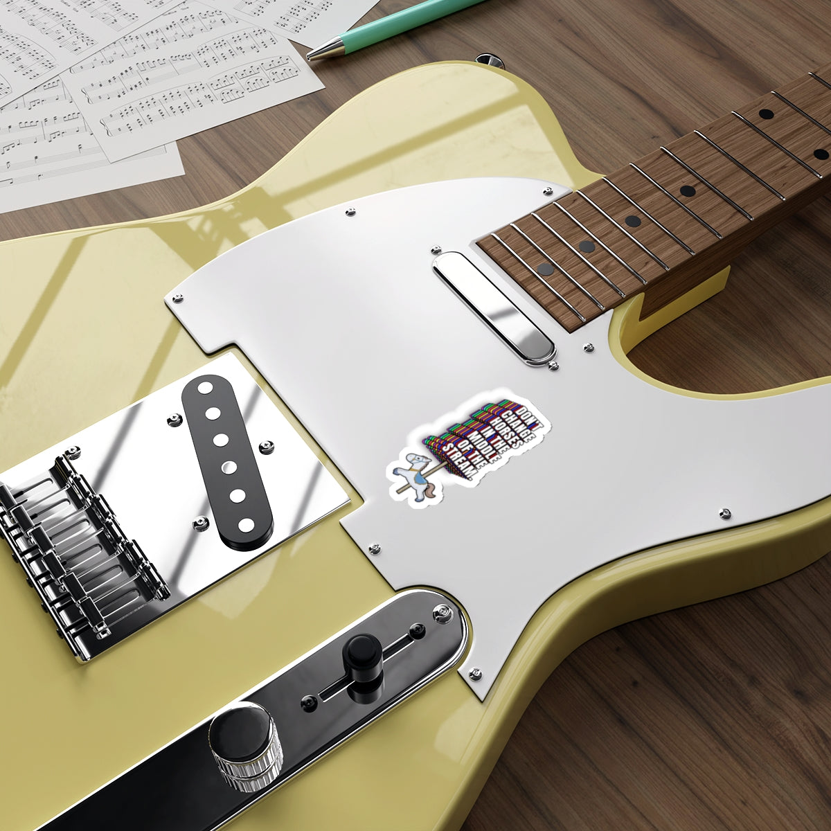 Yellow electric guitar decorated with Don’t Change Horses in the Middle of the Stream sticker
