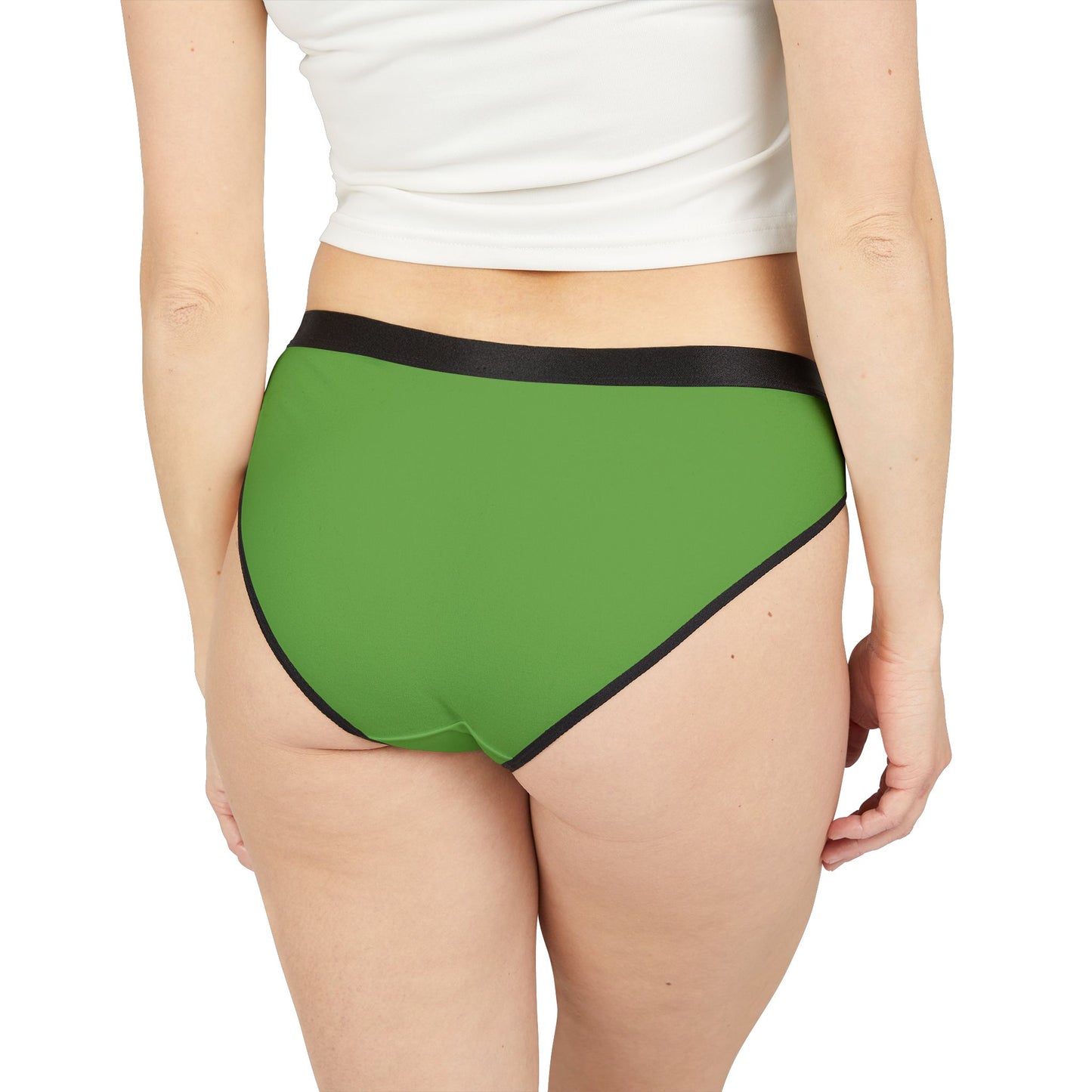 Green underwear with black trim worn by a person on a white background
