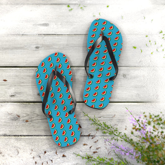 Pair of flip-flops with watermelon pattern on a wooden surface