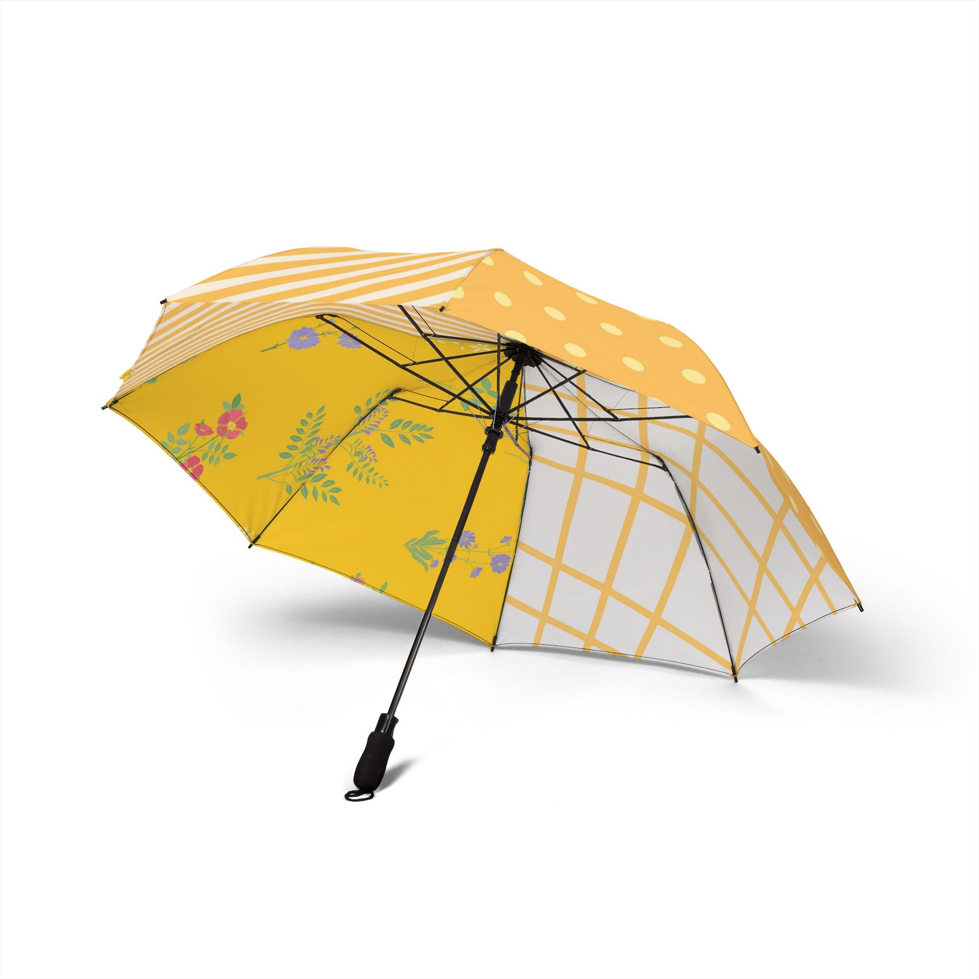 Side of a colorful patchwork umbrella with polka dots, stripes, florals, and grid patterns in yellow tones.
