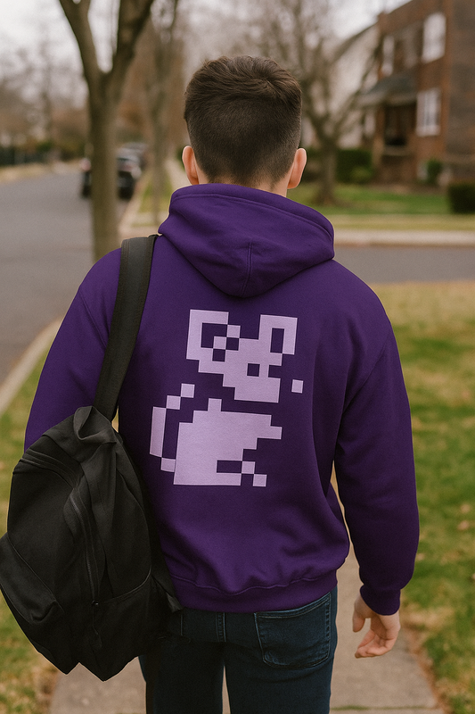 Person wearing a purple Pixel Mouse Zip Hoodie with white pixel mouse design on the back, walking down a suburban street with a black backpack.