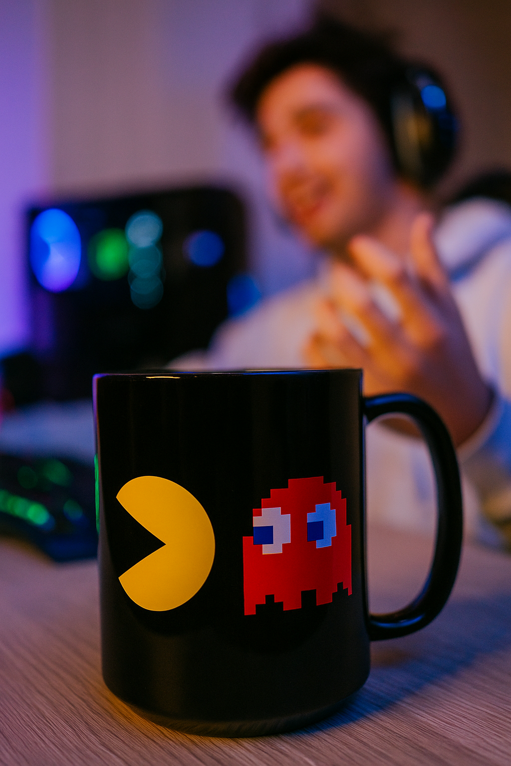 Black retro pixel arcade coffee mug in gaming setup with RGB lighting