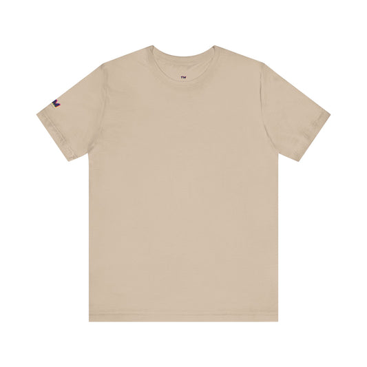 Beige t-shirt with a small flag patch on the sleeve against a white background